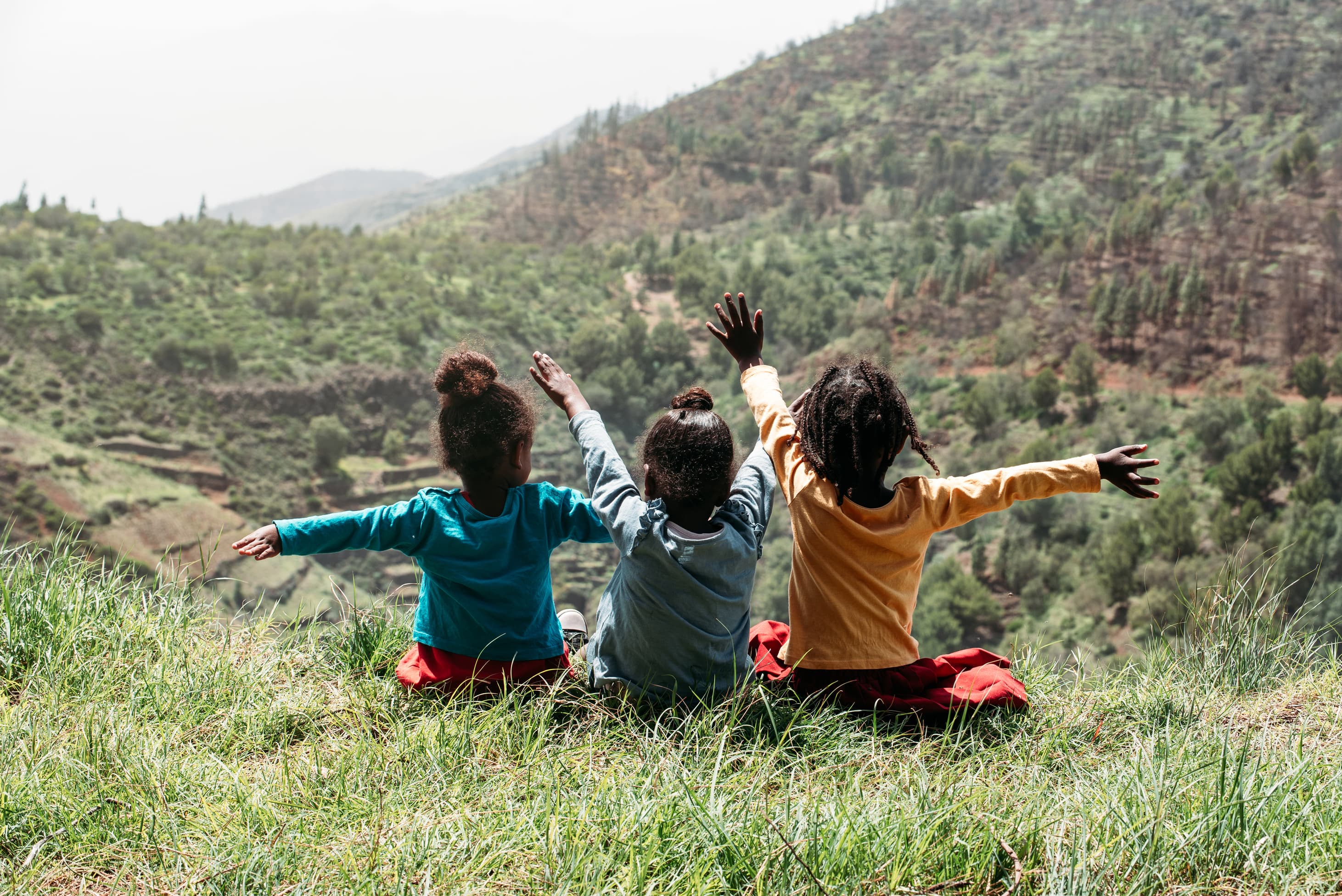 three children holding hands