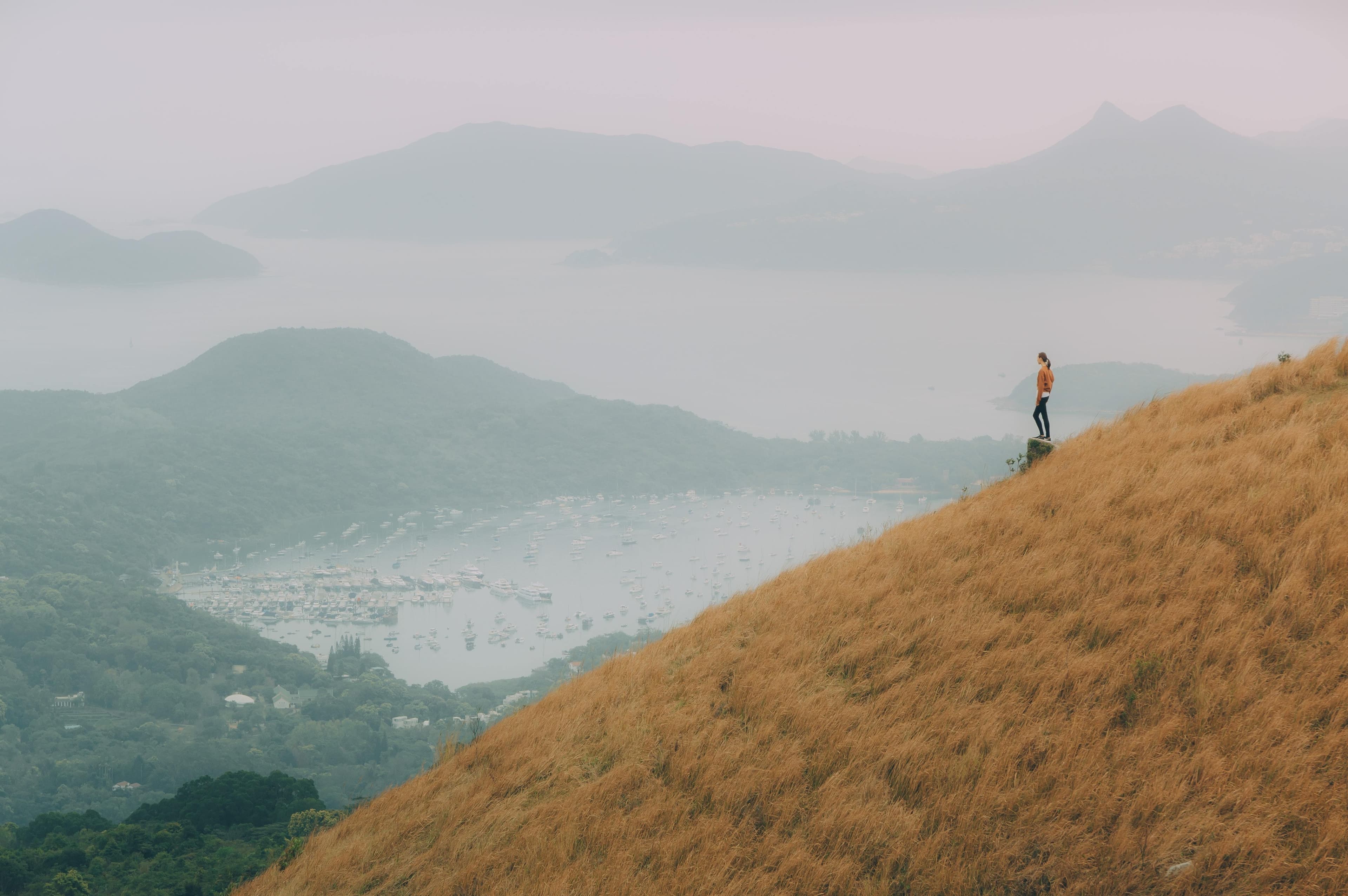 Woman standing on a hill looking out