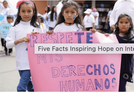 Children holding a banner