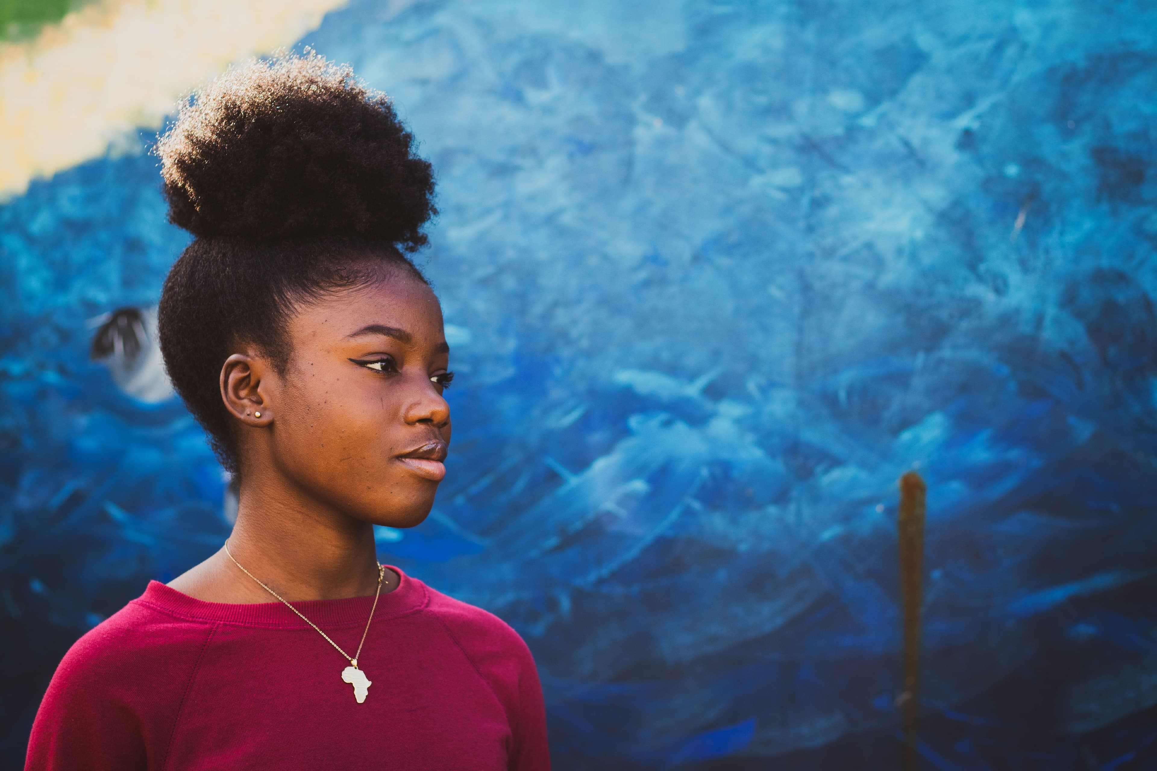 Adolescent girl blue wall