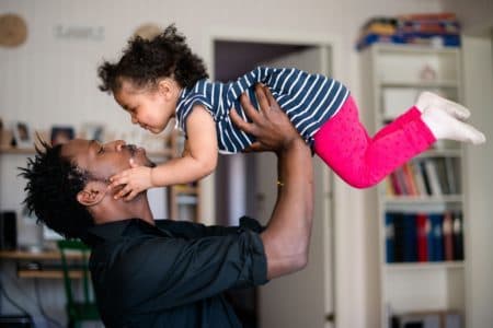 father carrying baby