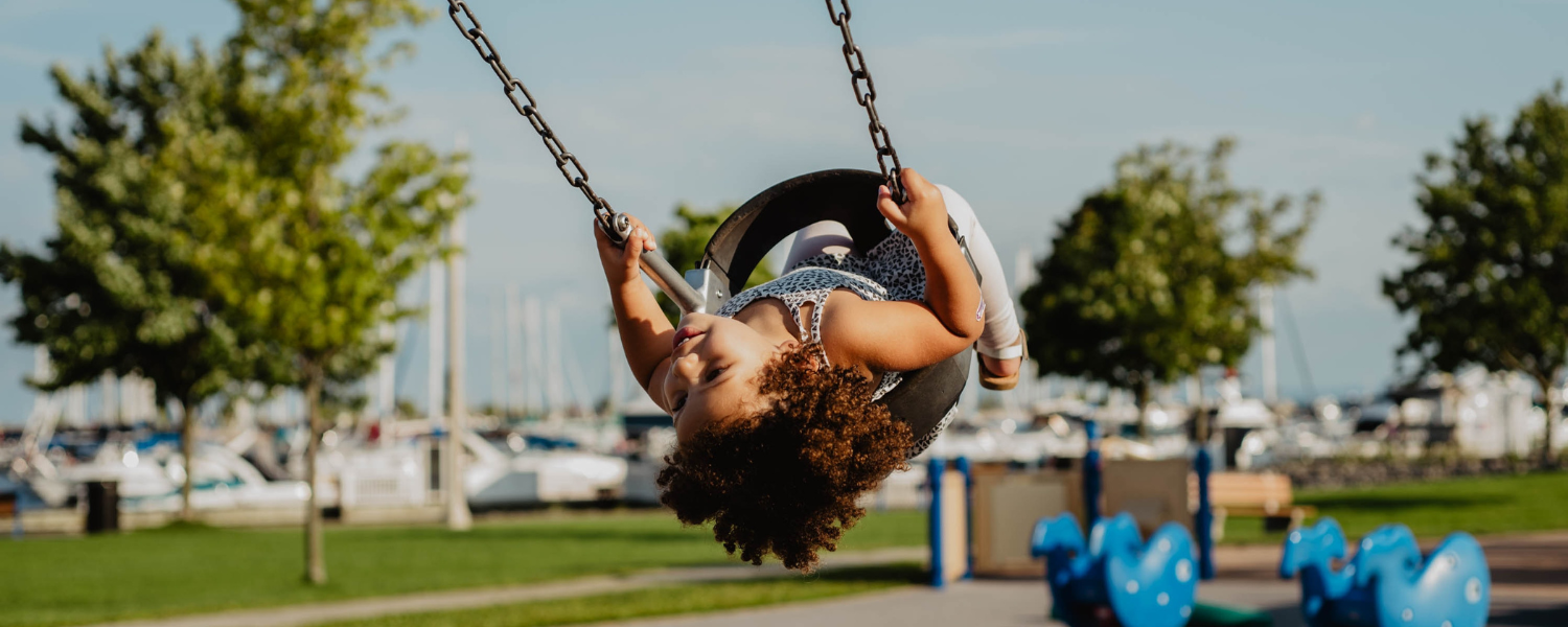 Girl swinging on tire swing