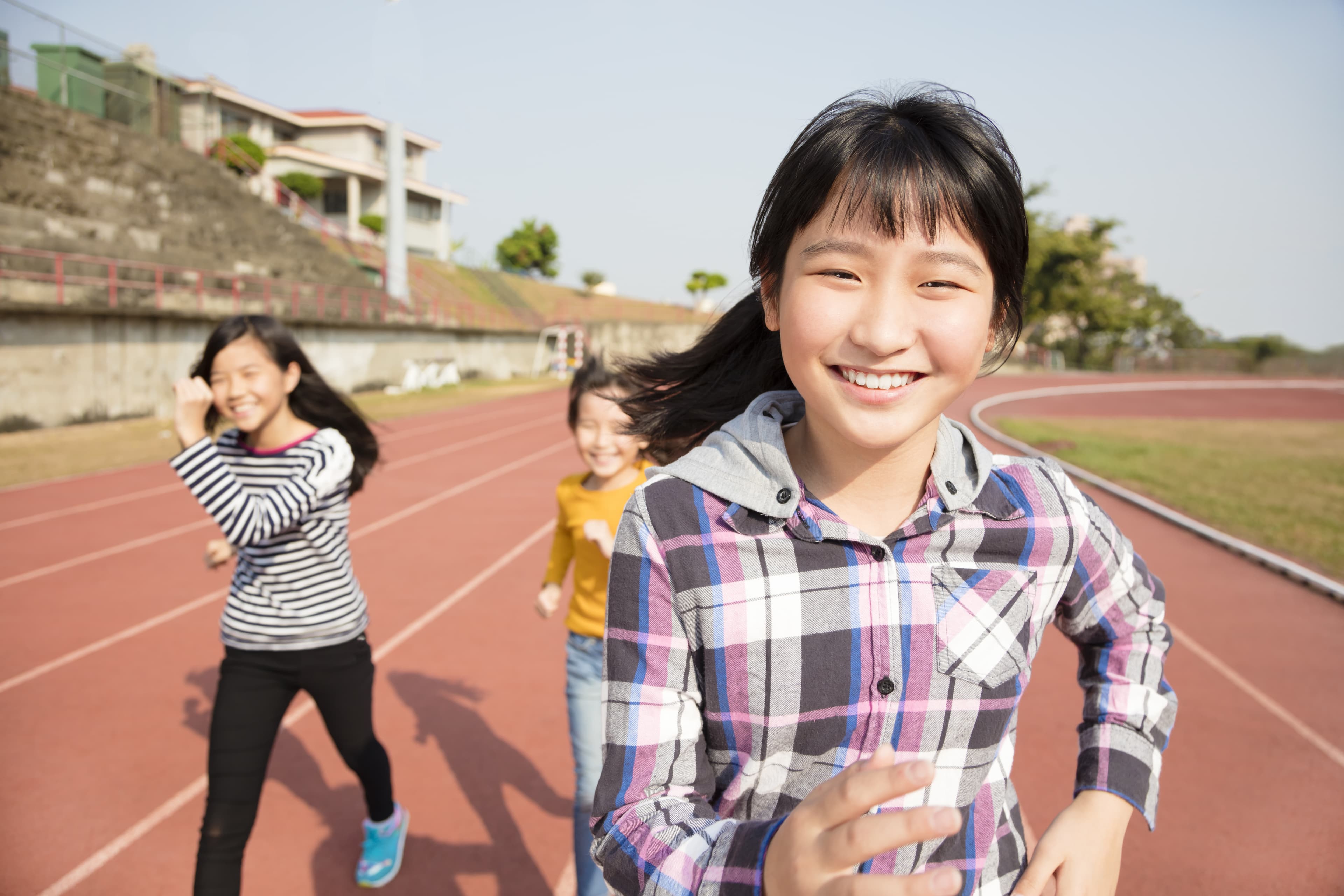 Girls running on track
