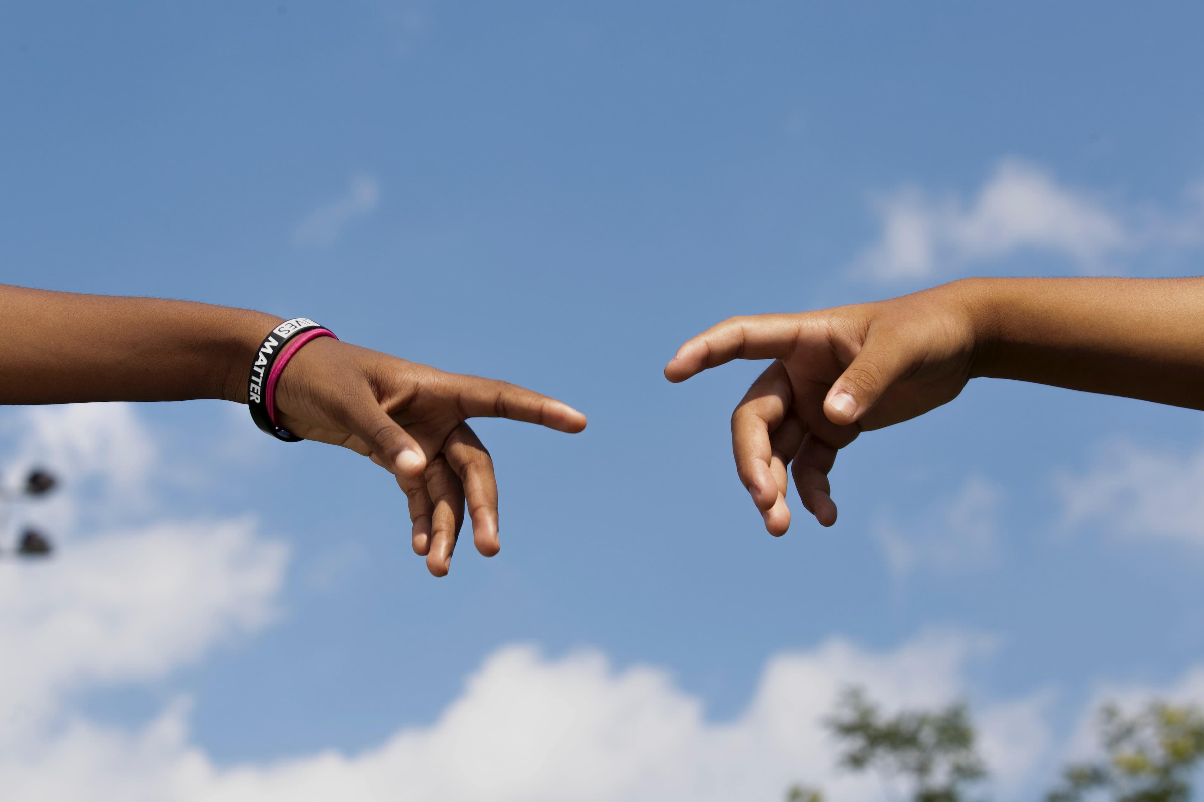 hands reaching out to touch