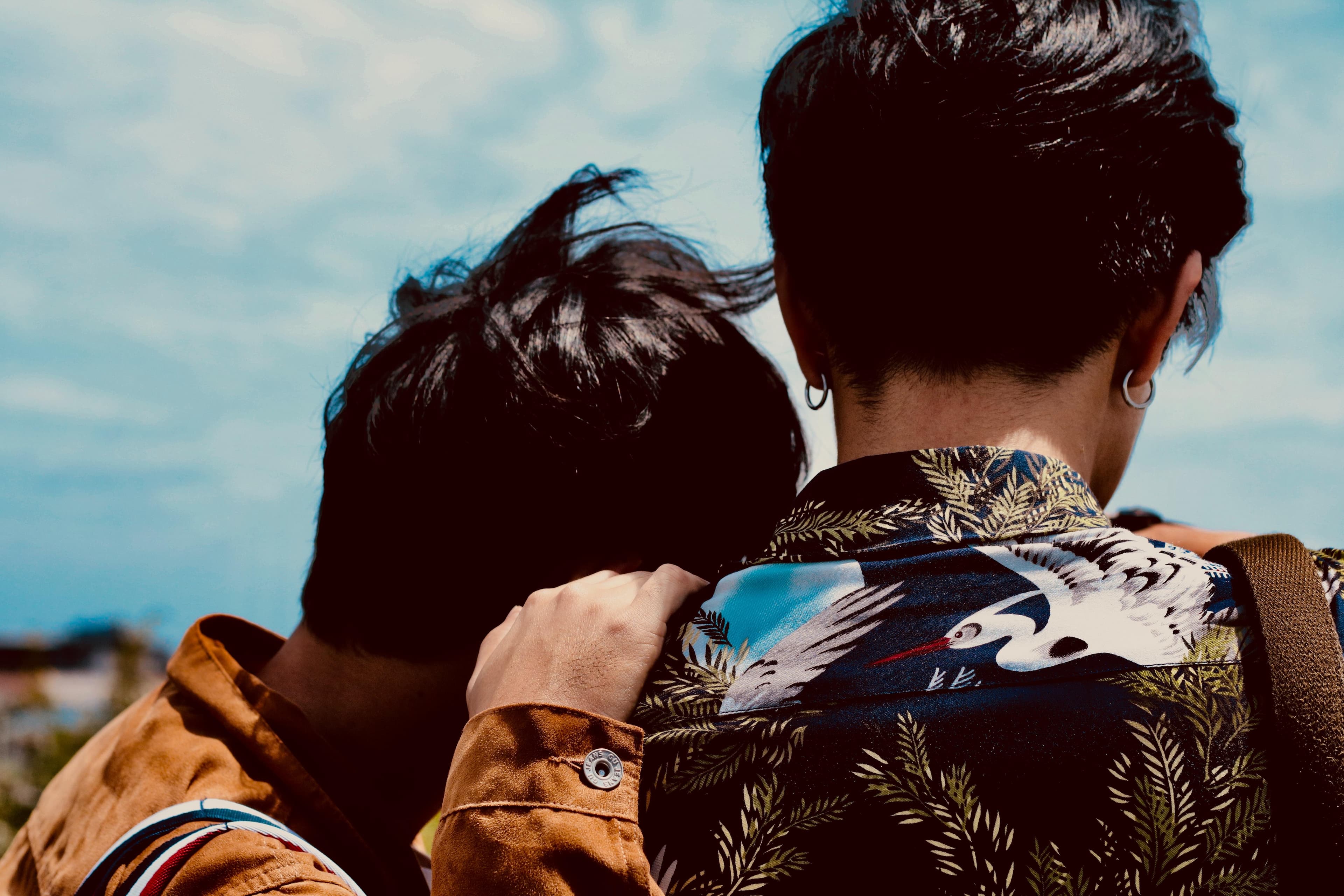 Two people together hand on shoulder