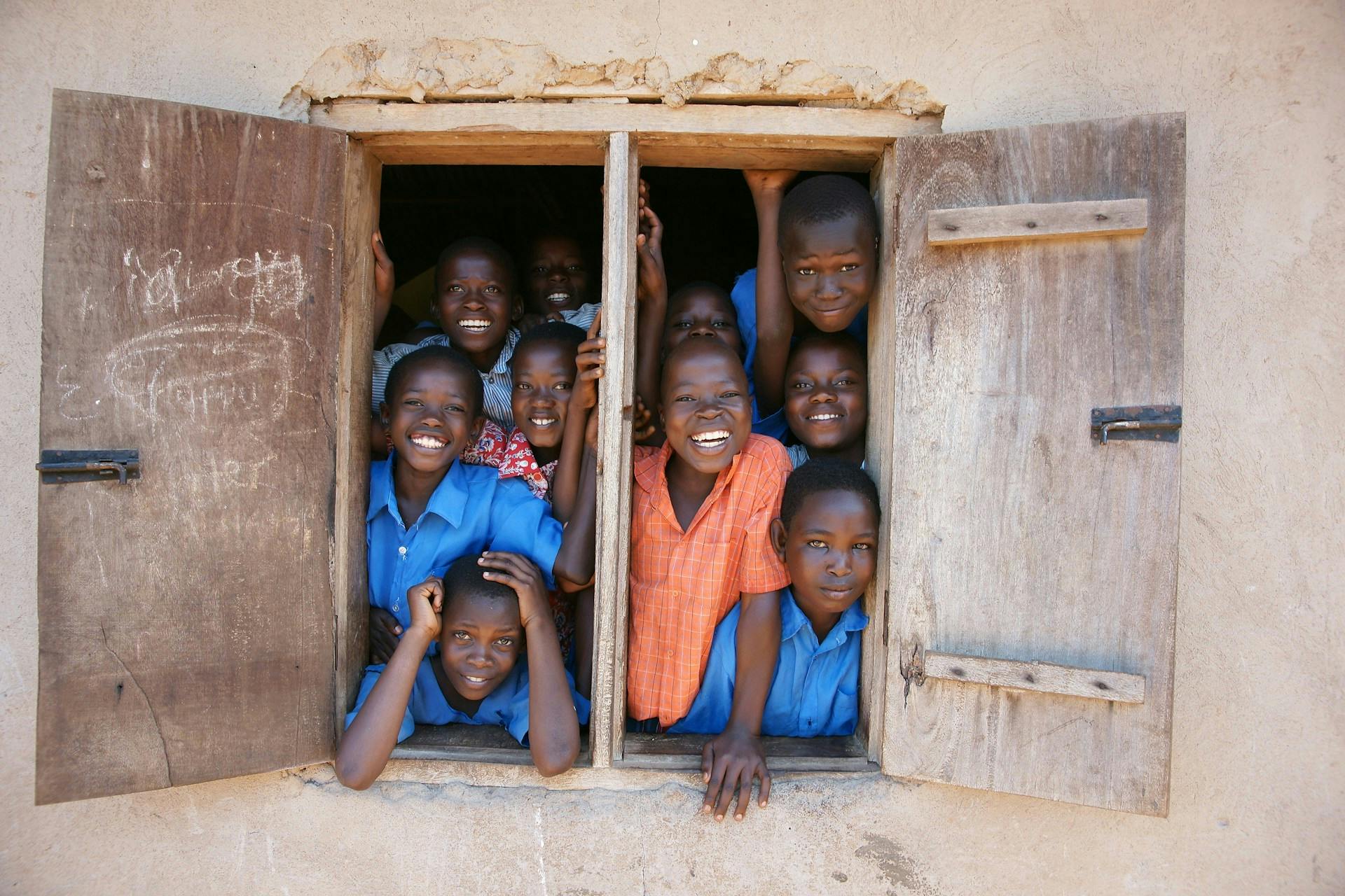 Ugandan boys at school window