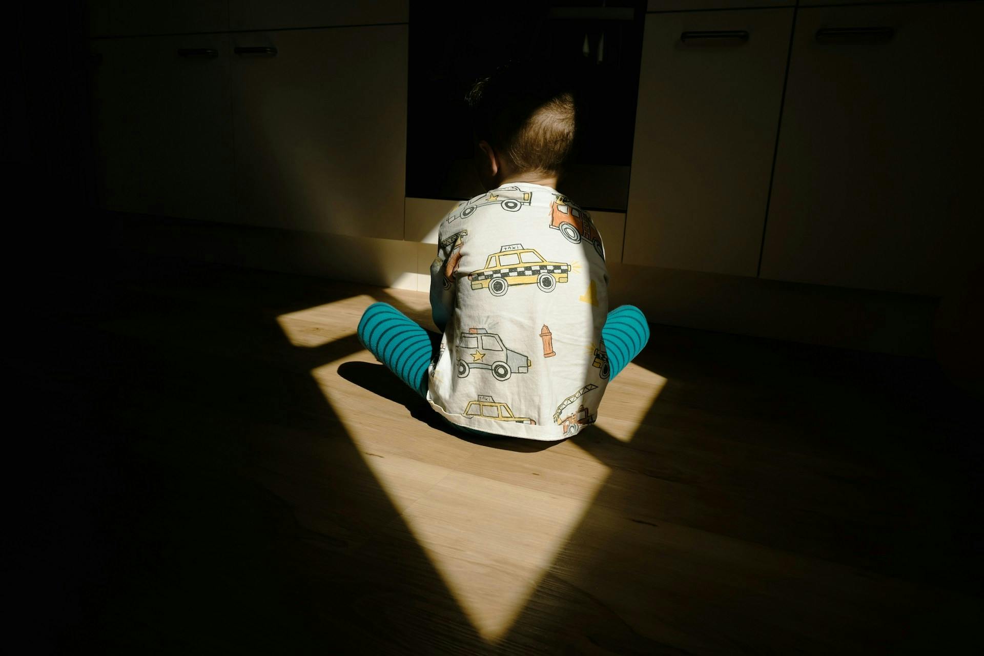 Boy sitting in shadow