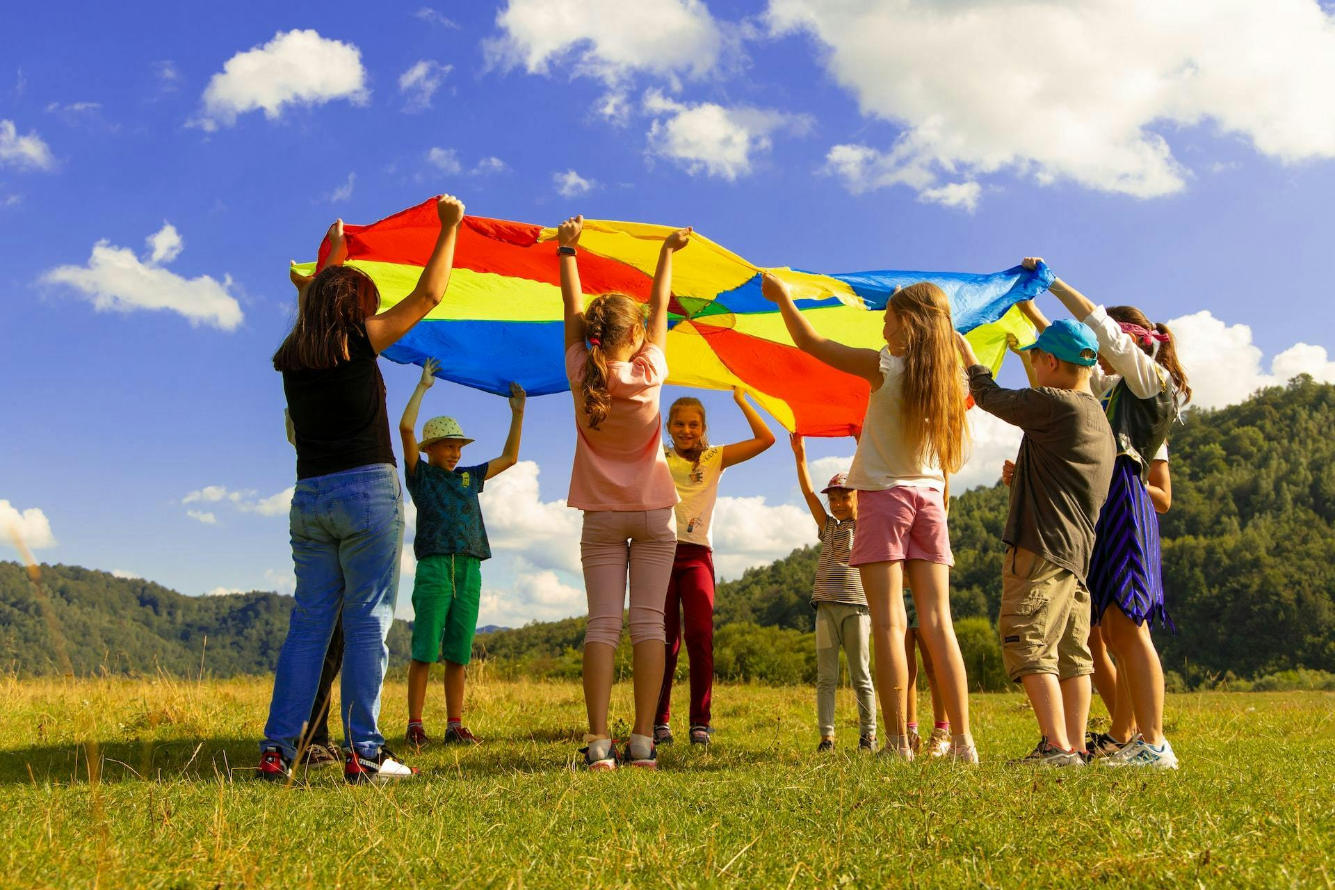 Children colored parachute in park