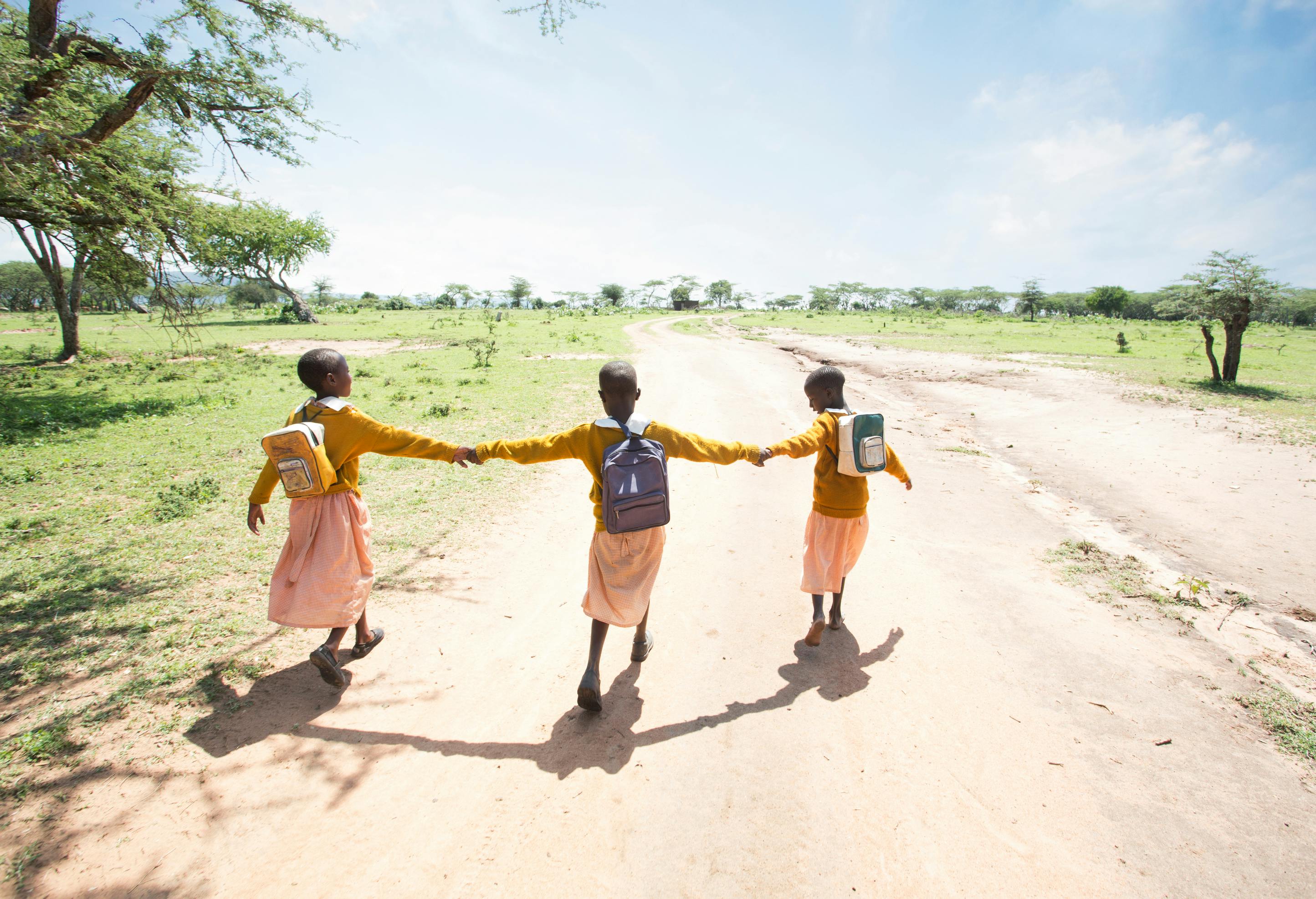 Three girls walking to school