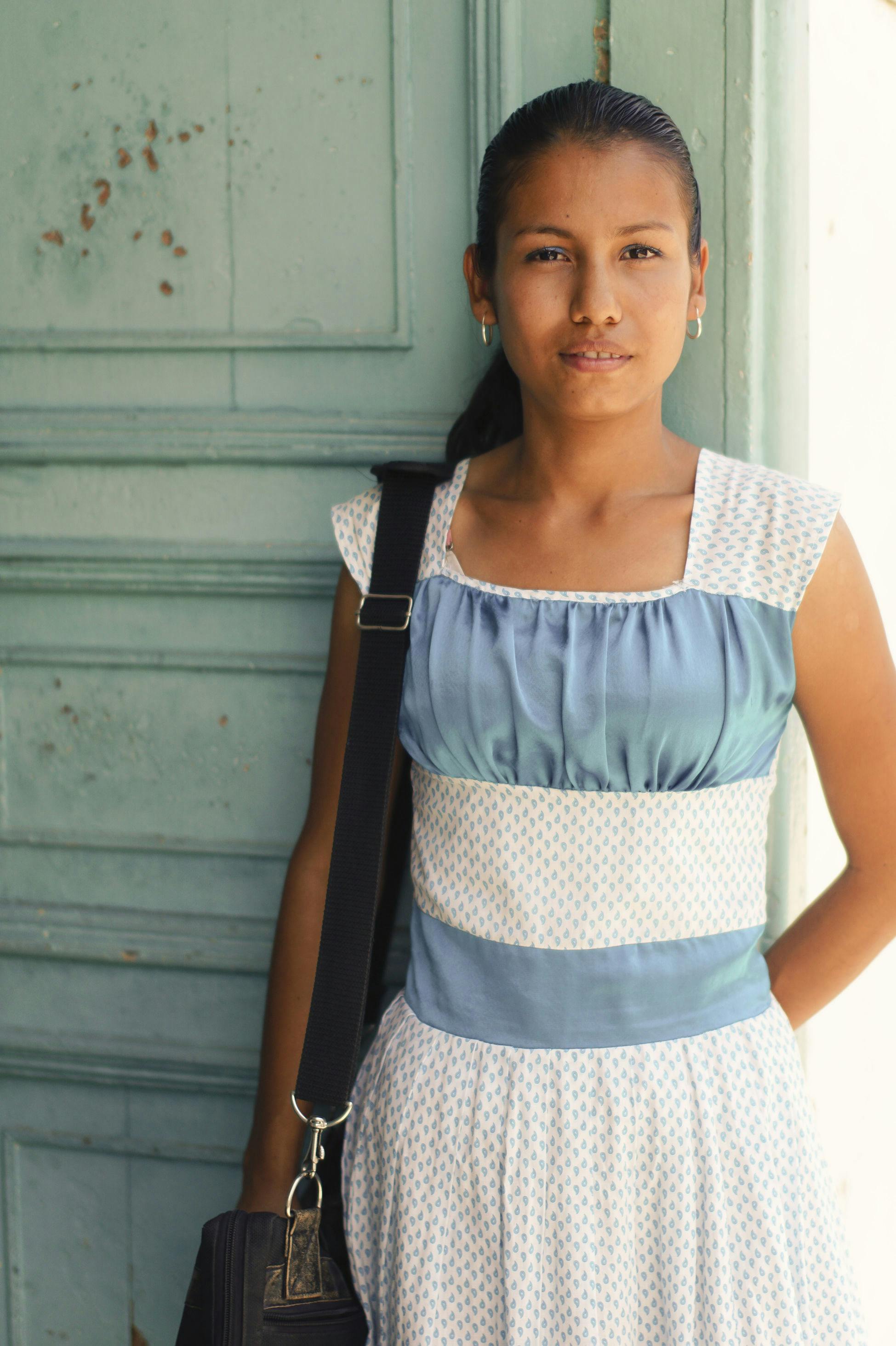 Young woman in blue and white dress from Colombia